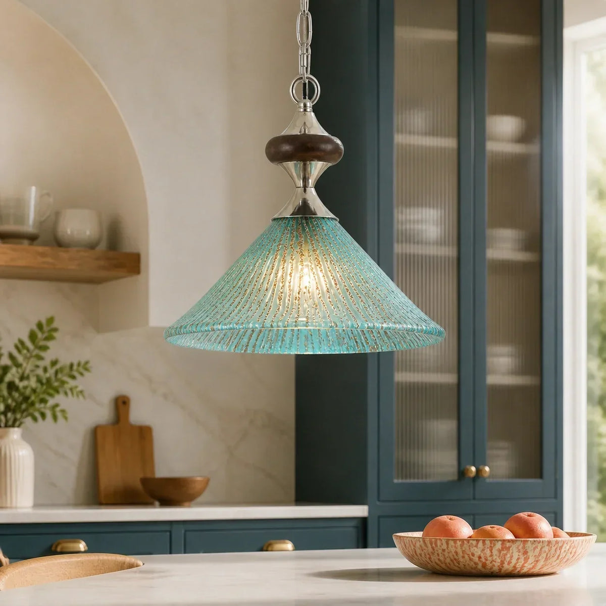 Green ribbed glass pendant glowing in a calm British kitchen island