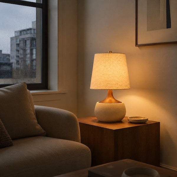 Mid-Century cement base linen table lamp brightening a dark modern living room corner