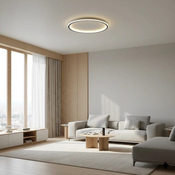 A spacious modern living room with soft, warm lighting and a minimalist round ceiling light as the central focus.