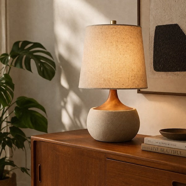 Mid-Century Modern living room featuring a cement base table lamp with a warm linen shade on a walnut sideboard.