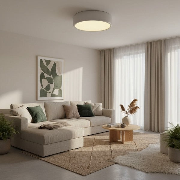 A tranquil living room setting with soft shadows and a warm circular ceiling light overhead.